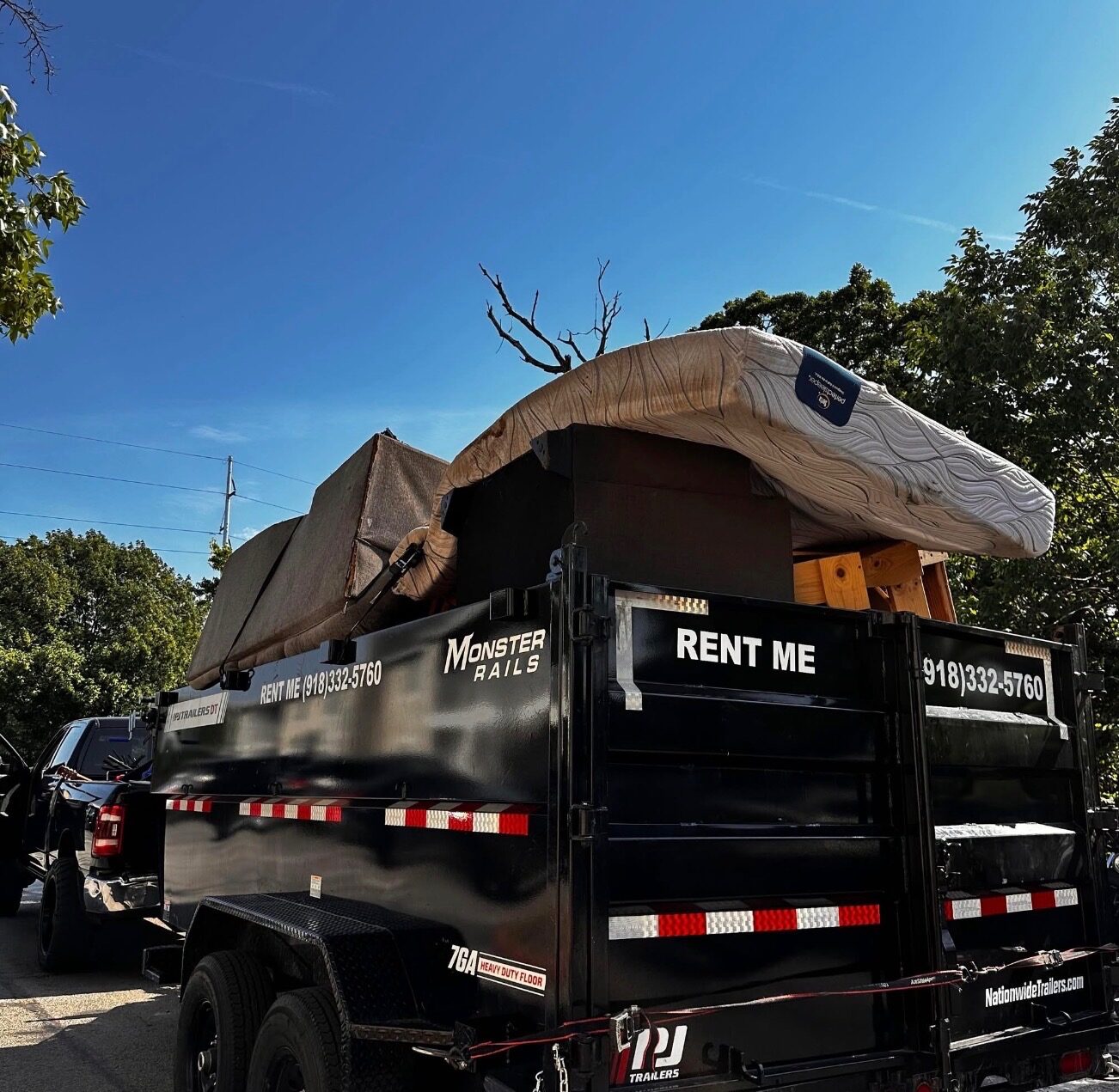 Junk removal truck loaded at dusk